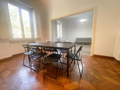 a dining room with a table and chairs at Angelico Boutique Apartment in Rome