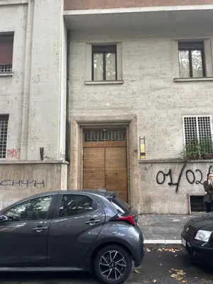 a car parked in front of a building with a garage at Angelico Boutique Apartment in Rome