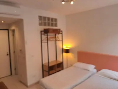 a bedroom with two beds and a shelf in it at Holidays S.Lorenzo Guest House New in Rome