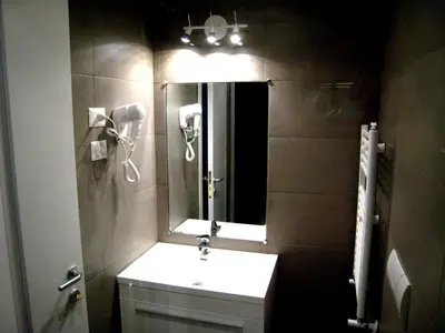 a bathroom with a sink and a mirror at Holidays S.Lorenzo Guest House New in Rome