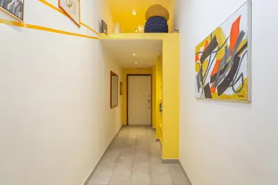 a hallway with yellow and white walls and a hallway with a door at Casa Stella in Rome