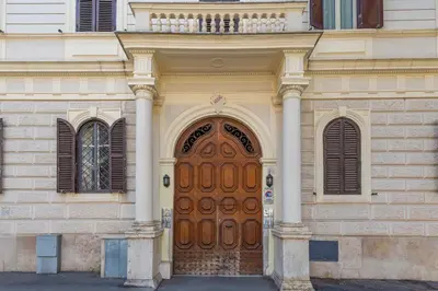 a building with a large wooden door with two columns at Casa Stella in Rome