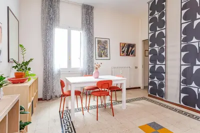 a dining room with a white table and red chairs at Casa Stella in Rome