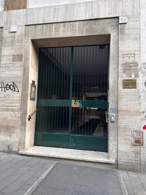 a building with a green door on the side of it at White flat Gallia in Rome