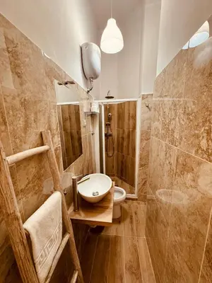 a bathroom with a sink and a toilet and a shower at Bencò House in Rome