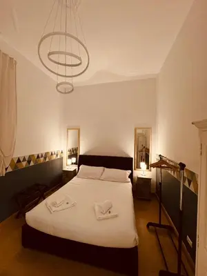 a bedroom with a bed with two towels on it at Bencò House in Rome