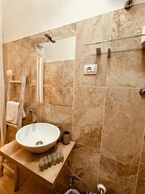 a bathroom with a sink and a shower at Bencò House in Rome