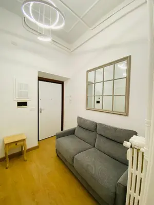 a living room with a couch and a window at Bencò House in Rome