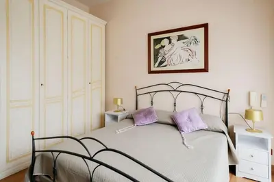 a bedroom with a bed with two purple pillows at Casa Angelina con 3 camere da letto in Rome