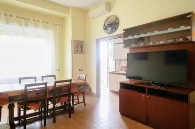 a dining room with a table and a flat screen tv at Casa Angelina con 3 camere da letto in Rome