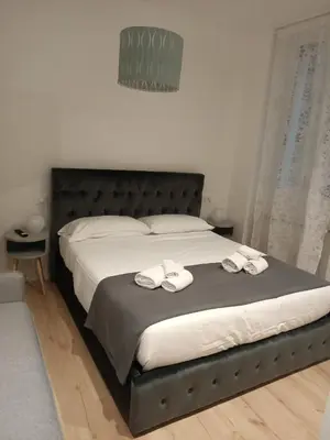 a bedroom with a bed with two towels on it at Harmony in Rome in Rome