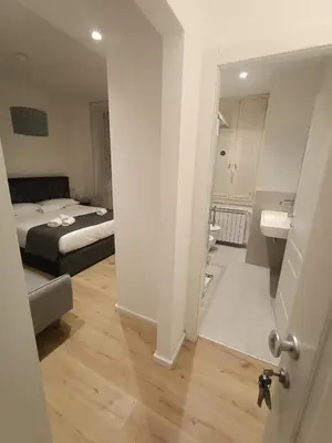 a room with a bed and a bathroom with a sink at Harmony in Rome in Rome