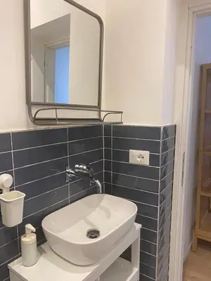 a bathroom with a white sink and a mirror at Harmony in Rome in Rome