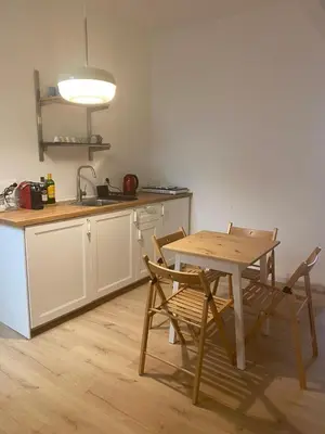 a kitchen with a table and chairs and a sink at Harmony in Rome in Rome