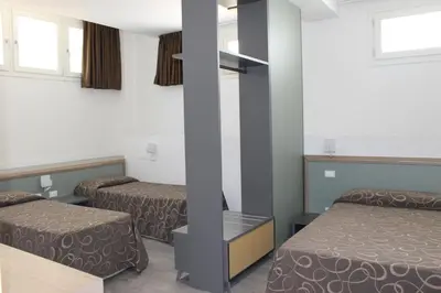 a room with two beds and a pole at Hotel Galileo in Rome
