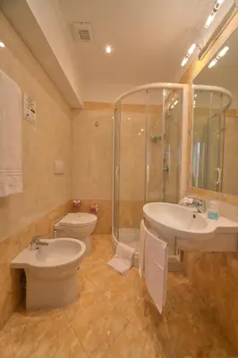 a bathroom with a toilet and a sink and a shower at Hotel Galileo in Rome