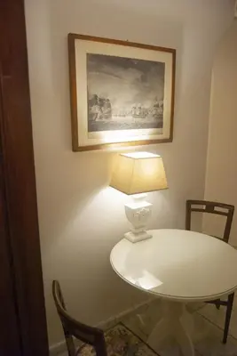 a table with a lamp and a picture on the wall at NEW! BELLISSIMO PalazzoFranchi Pantheon in Rome