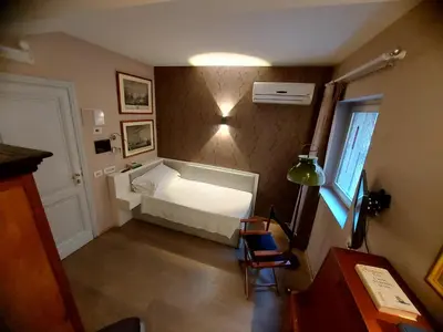 a bedroom with a white bed and a window at NEW! BELLISSIMO PalazzoFranchi Pantheon in Rome