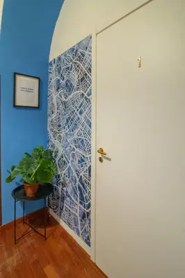 a dining room with a table and a refrigerator at Long John Apartment in Rome