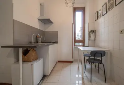 a white bathroom with a sink and a toilet at Long John Apartment in Rome