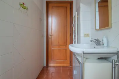 a kitchen with a sink and a table and chairs at Long John Apartment in Rome