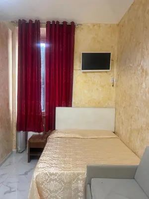 a bedroom with a bed and a red curtain at Termini Golden house in Rome