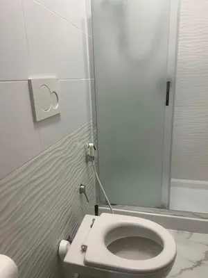 a white toilet in a bathroom with a mirror at Termini Golden house in Rome