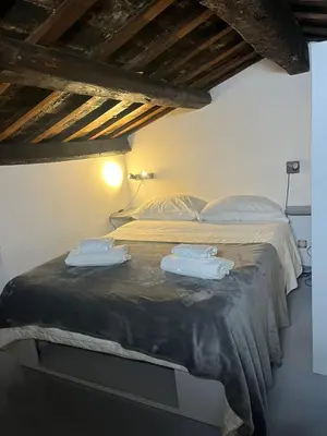 a bedroom with a bed with two towels on it at Vatican near Sweet Home Terrace in Rome