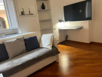 a living room with a couch and a flat screen tv at Vatican near Sweet Home Terrace in Rome