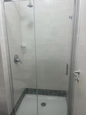a shower with a glass door next to a toilet at Roma Palace in Rome