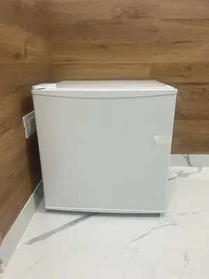 a white refrigerator sitting on the floor in a room at Roma Palace in Rome