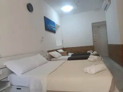 a hotel room with two beds with towels on them at Roma Palace in Rome