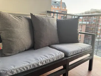 a living room with a couch and a flat screen tv at Tiburtina FLAM guest house in Rome