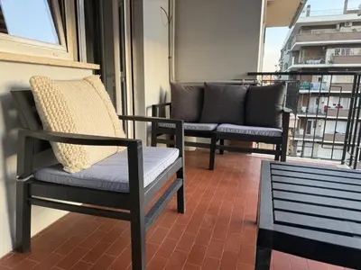 a living room with a plant in front of a sliding glass door at Tiburtina FLAM guest house in Rome
