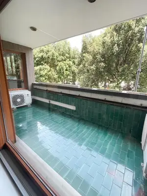 a large swimming pool with a window in a house at Mazzini Boutique Apartment in Rome