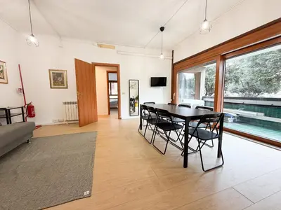 a dining room with a table and chairs and a pool at Mazzini Boutique Apartment in Rome