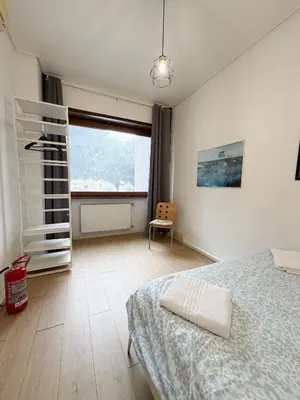 a bedroom with a bed and a window and a chair at Mazzini Boutique Apartment in Rome