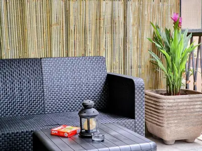 a blue couch and a table with a lamp and a plant at Grazia Guesthouse in Rome