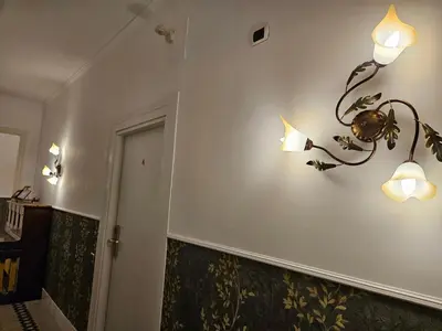 a hallway with two lights on a wall at 4rooms In Rome in Rome