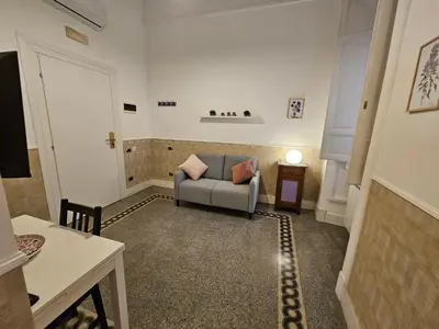 a living room with a couch and a table at 4rooms In Rome in Rome