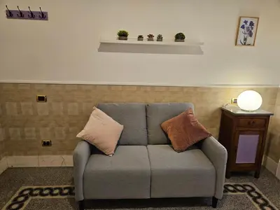 a couch with pillows on it in a living room at 4rooms In Rome in Rome