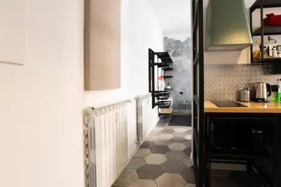 a kitchen with a counter and a table in a room at Apartment in front of Vatican Museums and Vatican area - myDen in Rome in Rome