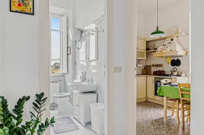 a living room with a piano and a mirror at Bright Vatican Suite - Garden View Balcony & Full Kitchen in Rome