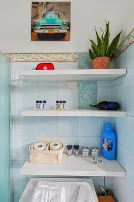 a white bathroom with a sink and a toilet at Bright Vatican Suite - Garden View Balcony & Full Kitchen in Rome