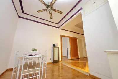 a dining room with a coffered ceiling and a table and chairs at Sanctuary Home 32 in Rome