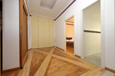 a hallway with white walls and wood floors and a bedroom at Sanctuary Home 32 in Rome