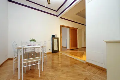 a room with a table and chairs and a ceiling at Sanctuary Home 32 in Rome