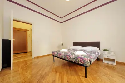 a bedroom with a bed in the middle of a room at Sanctuary Home 32 in Rome