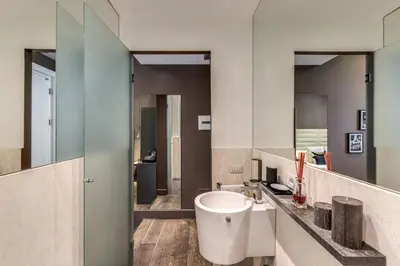 a bathroom with a sink and a mirror at Telier Tomacelli in Rome