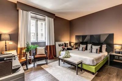 a bedroom with a large bed and a tv at Telier Tomacelli in Rome
